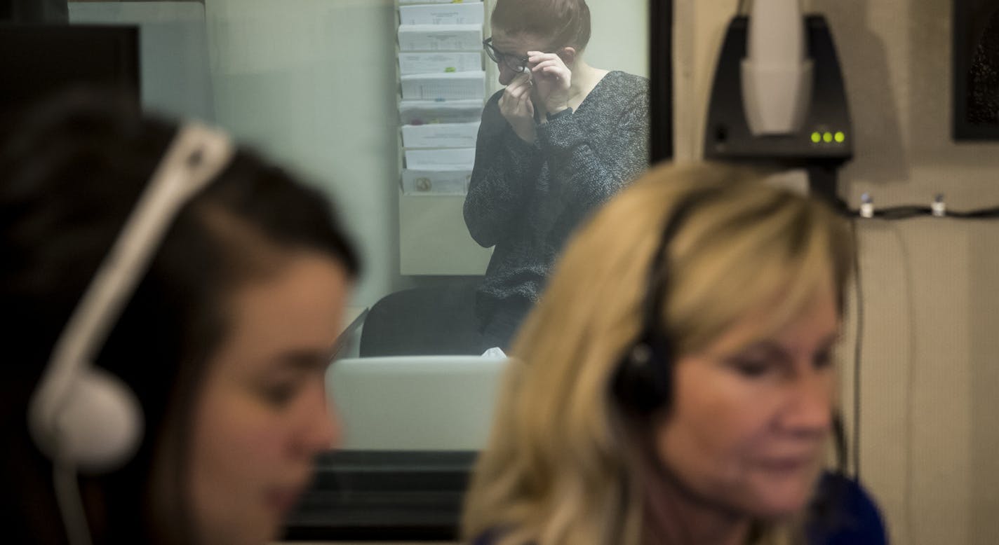 Logan EickHoff, 21, was brought to tears as she watched through a viewing window her mother Wendy Eickhoff, foreground right, as she spoke into a headset to record herself speaking sentences at the University of Minnesota on Friday, March 3, 2017, in Minneapolis, Minn. Wendy Eickhoff has ALS and is recording her voice to use later on when the disease progresses so she has the ability to communicate in her own voice. ] RENEE JONES SCHNEIDER &#x2022; renee.jones@startribune.com The University of M