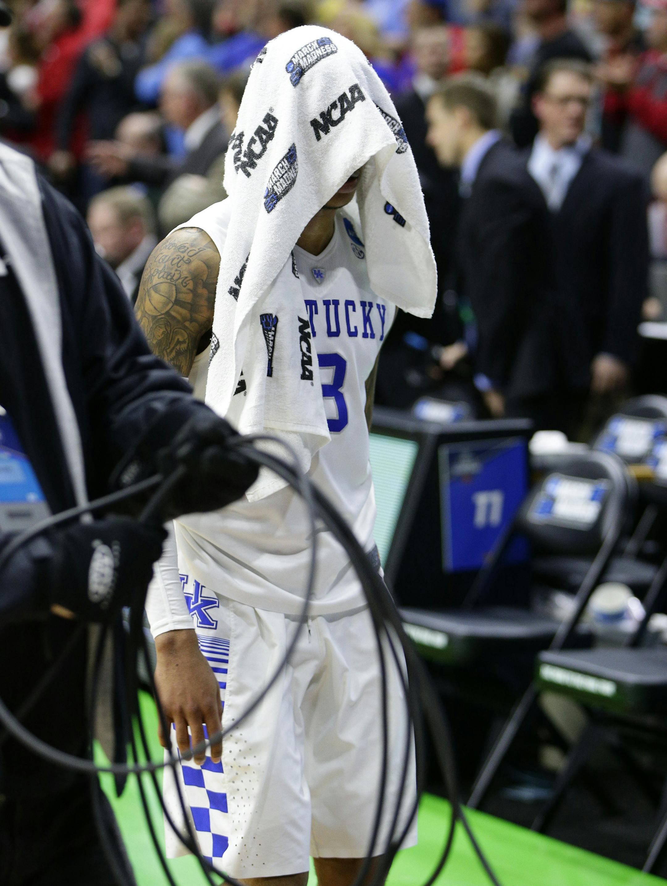 Kentucky's Tyler Ulis (3) walks quietly off the floor under the cover of a towel following a 73-67 loss against Indiana in the second round of the NCAA Tournament on Saturday, March 19, 2016, at Wells Fargo Arena in Des Moines, Iowa. (Mark Cornelison/Lexington Herald-Leader/TNS)