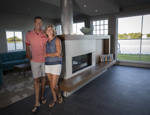 Owners Angie and Lenny Koch in the living room/kitchen of their Lindstrom, Minn., home, designed by by Kell Architects.