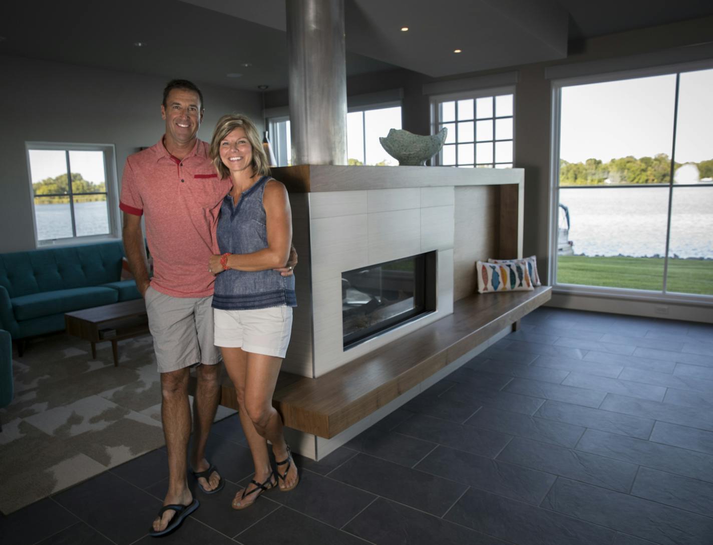 Owners Angie and Lenny Koch in the living room/kitchen of their Lindstrom, Minn., home, designed by by Kell Architects.