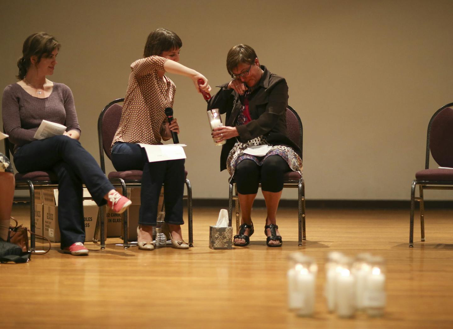 Sarah Super lit a candle held by Michele Heyer after she shared her story at the "Break the Silence Day" gathering Tuesday night in Minneapolis. All the participants who shared their experiences placed a candle at the center of the room when they were finished, 13 in all. ] JEFF WHEELER &#x2022; jeff.wheeler@startribune.com Survivors of sexual violence gathered at the Ukrainian Event Center in Minneapolis Tuesday night, August 18, 2015 to speak up and out about sexual violence for "Break the Sil