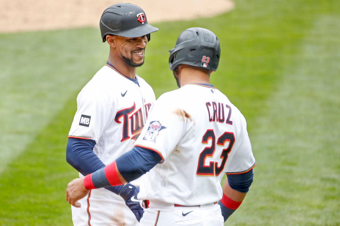 Minnesota Twins' Byron Buxton, left, celebrates with Nelson Cruz, right.