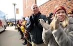 Michael and Bonnie Moe, now living in San Francisco, cheered for the Minnesota Gophers as they arrived outside Kinnick Stadium Saturday before their g