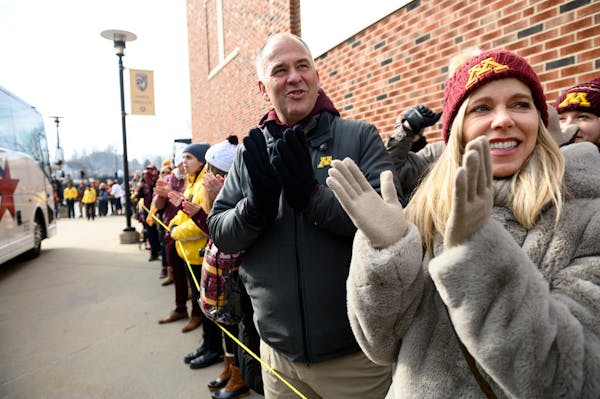 Michael and Bonnie Moe, now living in San Francisco, cheered for the Minnesota Gophers as they arrived outside Kinnick Stadium Saturday before their g