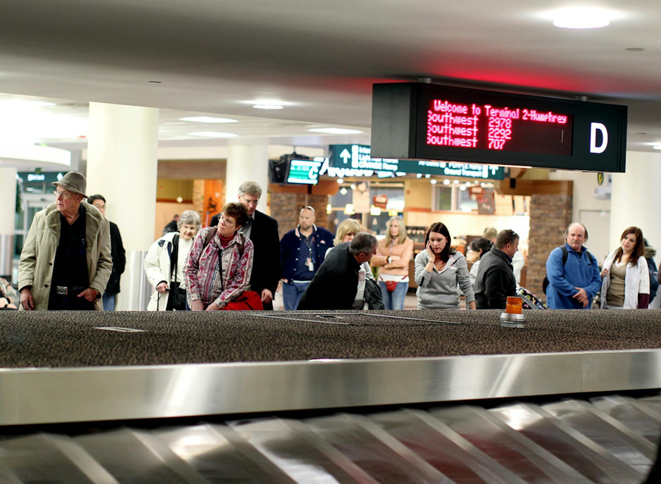 Travelers at Minneapolis-St. Paul International Airport.