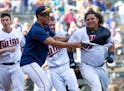 Willians Astudillo, right, was mobbed by teammate Jose Berrios after hitting a two-run walk-off home run on Sept. 9.