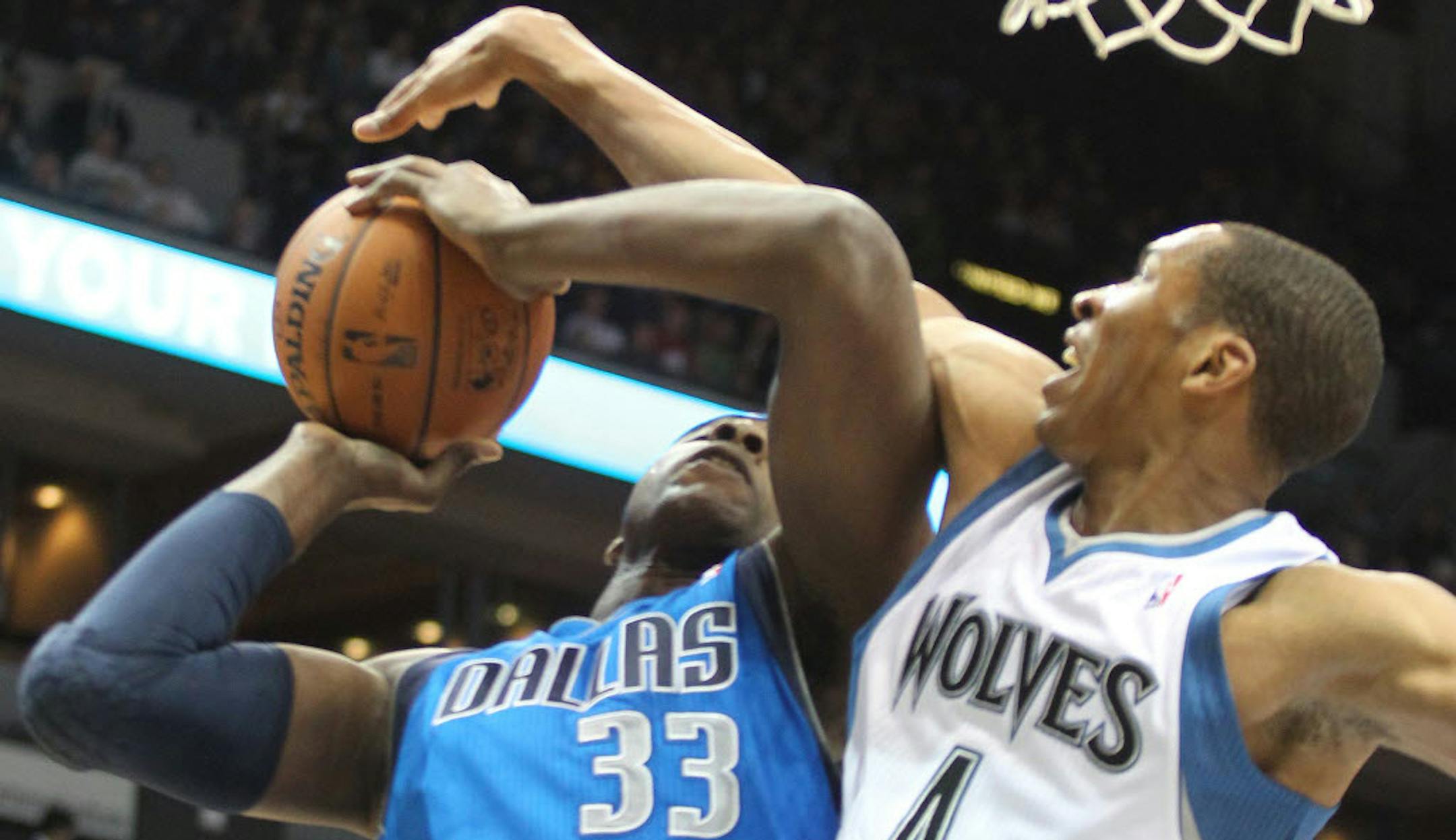 The Wolves' Wes Johnson (4) blocked a shot by Dallas' Grendan Haywood.
