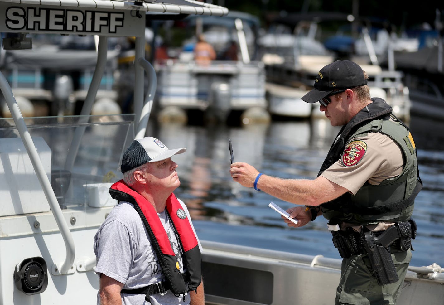 The DNR and other law enforcement agencies are kicking off Operation Dry Water, a concerted effort to crack down on drunken boaters this weekend. The goal: reducing the number of BWI accidents and fatalities. Here, Dale Erickson volunteered for a seated battery and field sobriety test on a Washington County Sheriff's boat as Alexander Birdsall, a Minnesota DNR conseration officer, administered the sobriety test Thursday, June 28, 2018, in Stillwater, MN.] DAVID JOLES &#xef; david.joles@startribu