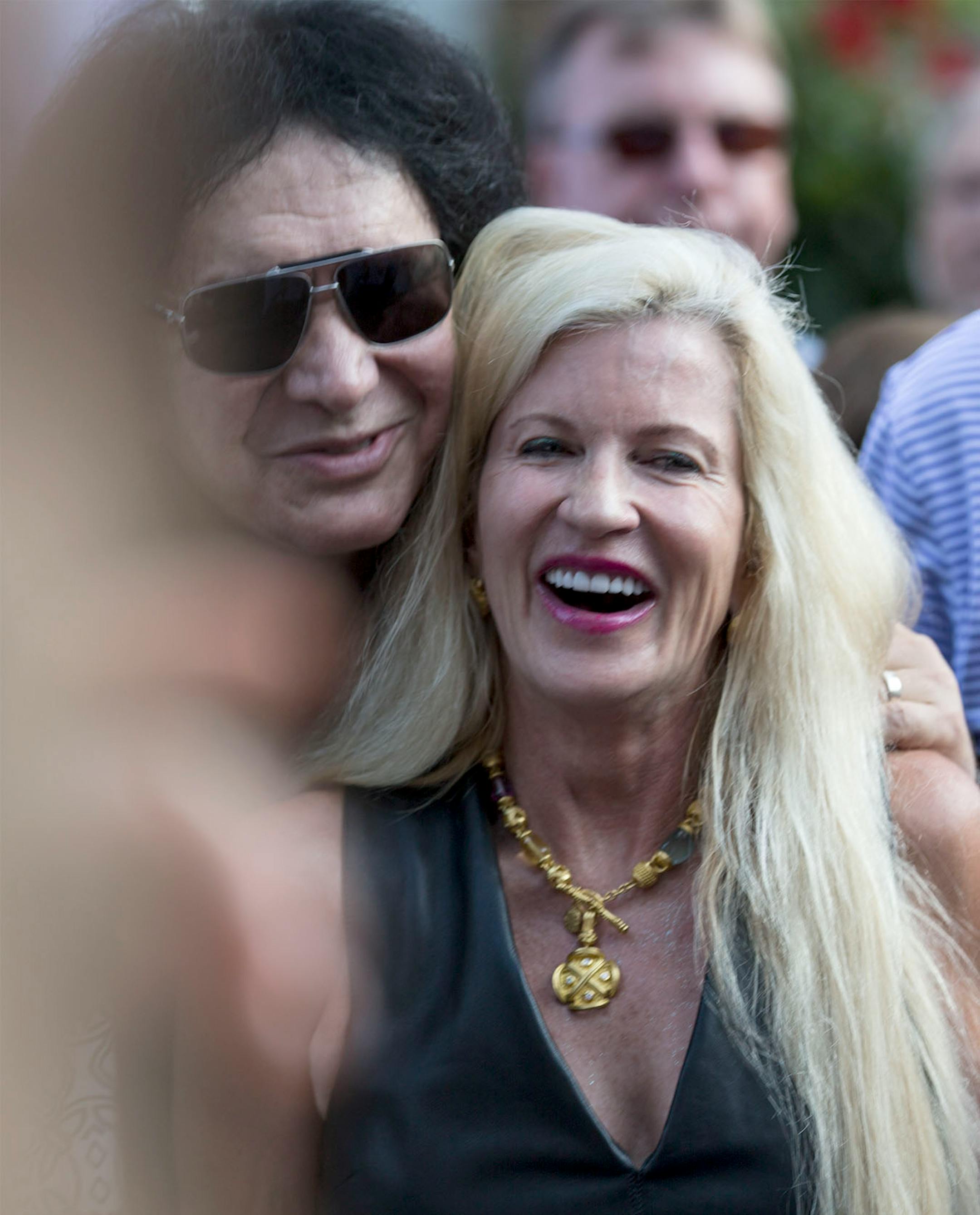 Kiss' Gene Simmons posed for pictures philanthropist Martha "Muffy" MacMillan before a charity concert at her house on Tuesday, August 2, 2016, in Long Lake, Minn.