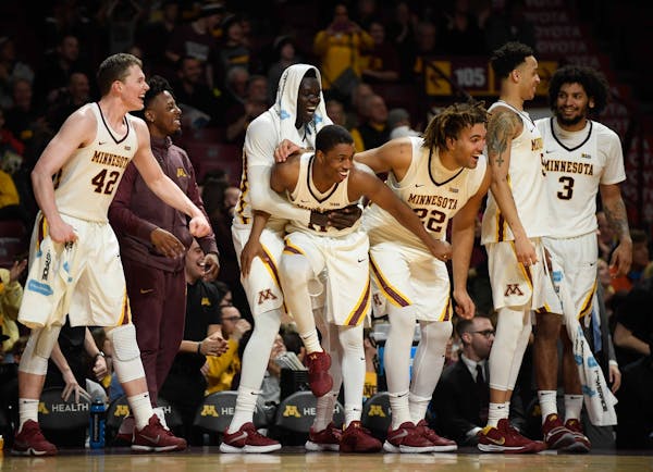 The Minnesota Golden Gophers bench erupted after a reverse layup by guard Hunt Conroy (13) late in the second half Saturday against the Florida Atlant