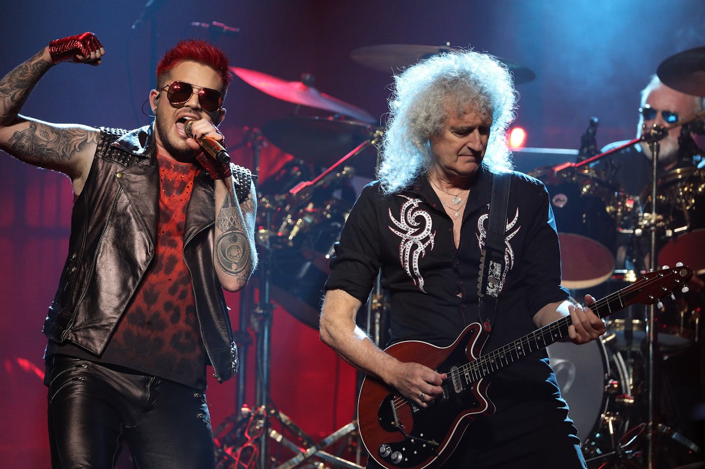 Singer Adam Lambert and guitarist Brian May stood in front of drummer Roger Taylor on stage during Friday night's Queen performance at the Xcel Energy Center.