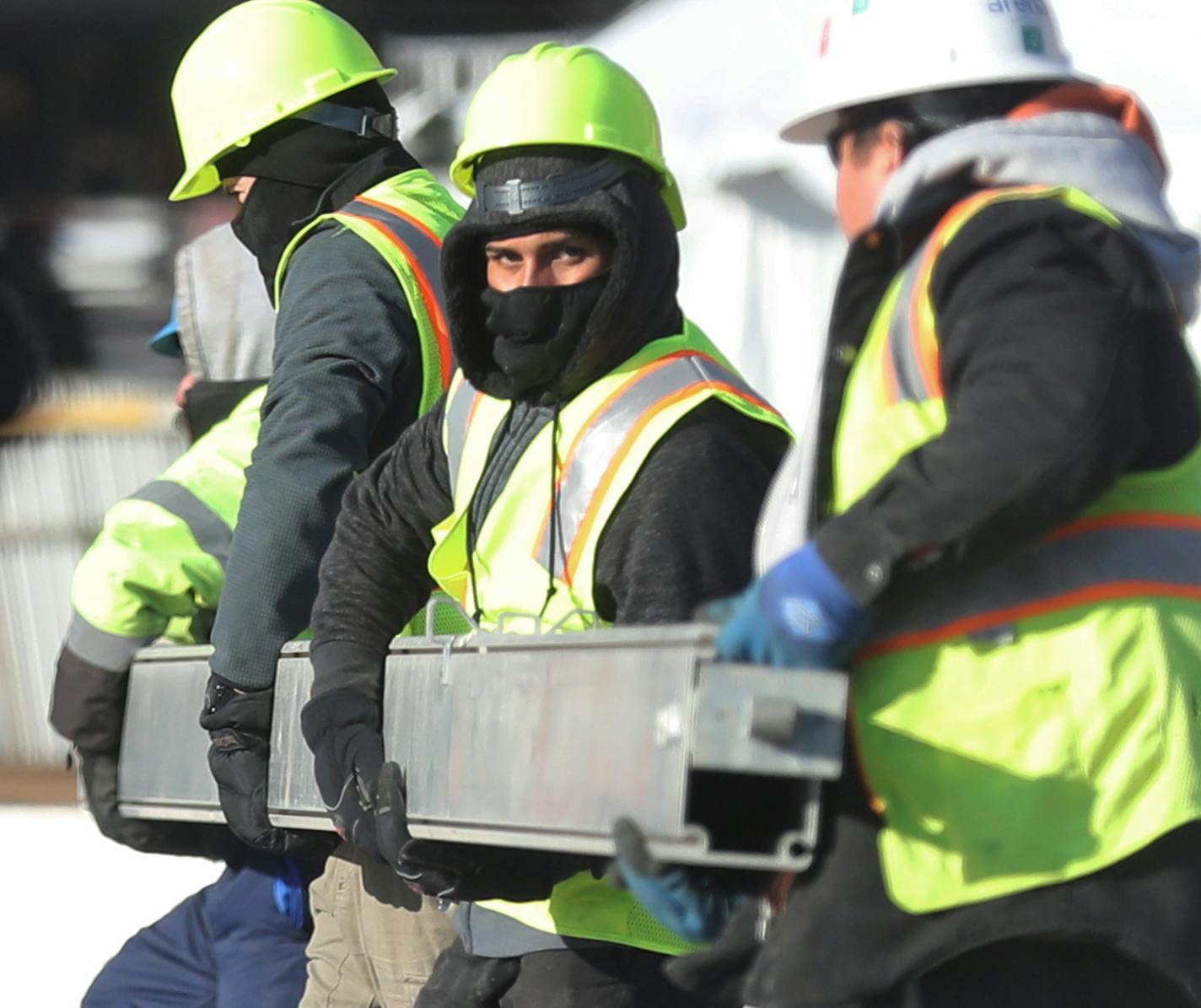 Construction workers moved a metal beam as the Commons is readied for the Super Bowl, near U.S. Bank Stadium in downtown Minneapolis.