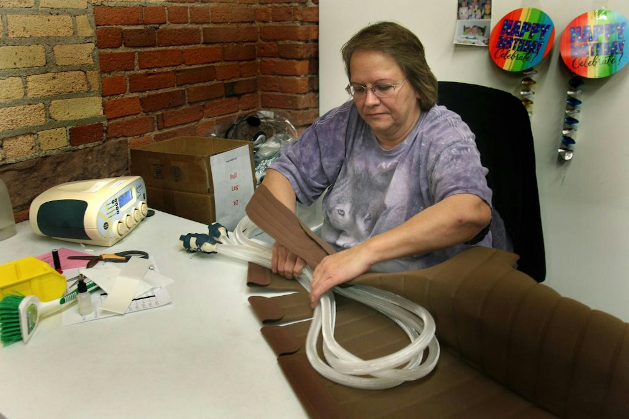 Tactile Systems Technology Manufacturing Specialist Leslie Ruble assembled and tested a device that helps people with lymphedema treat themselves at home, at the Minneapolis headquarters, Tuesday, October 16, 2012. (ELIZABETH FLORES/STAR TRIBUNE) ELIZABETH FLORES � eflores@startribune.com