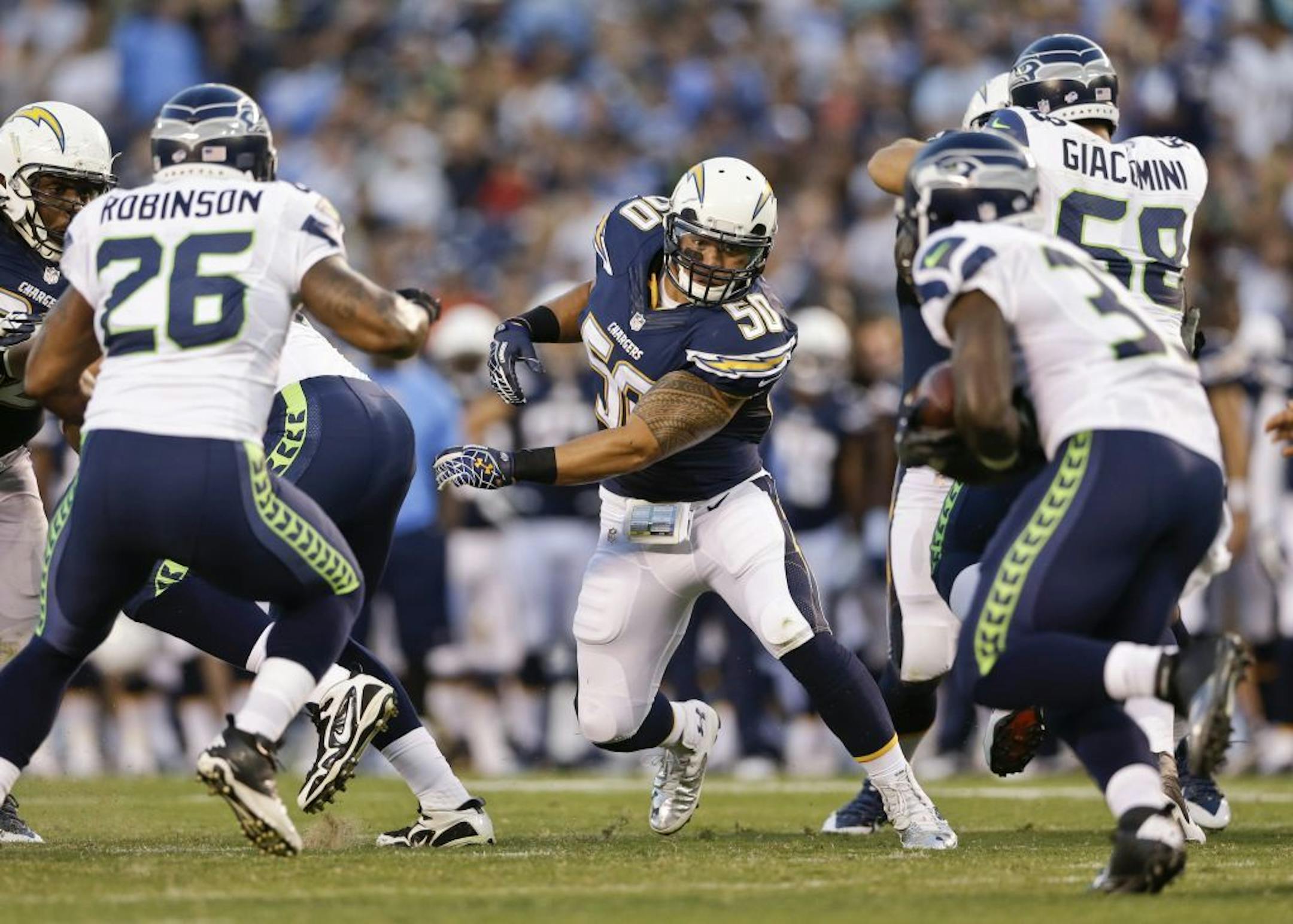 San Diego Chargers inside linebacker Manti Te'o takes aim on Seattle Seahawks running back Christine Michael in the second quarter of an NFL preseason football game Thursday, Aug. 8, 2013, in San Diego.