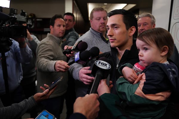 Minnesota Wild defenseman Jared Spurgeon (46) held his son Jayce, 1, as he spoke with reporters in the locker room Tuesday. ] ANTHONY SOUFFLE &#x2022;