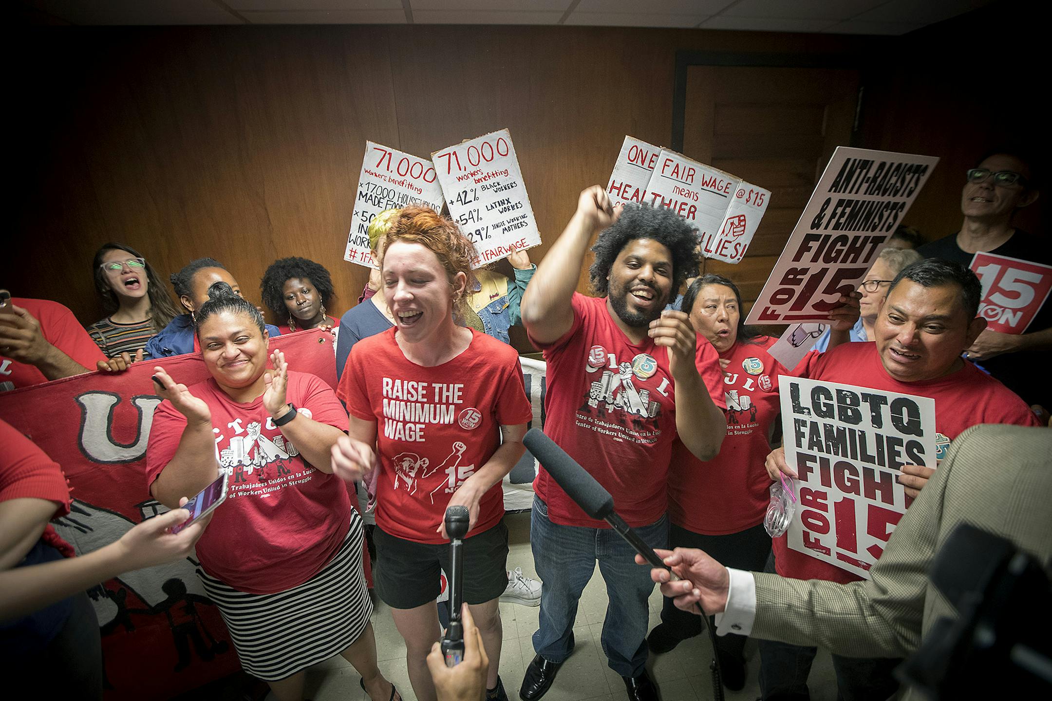 Minneapolis city council candidate Ginger Jentzen, center, celebrated with other supporters of the $15 minimum wage increase after it was passed by City Council at City Hall, Friday, June 30, 2017 in Minneapolis, MN. ] ELIZABETH FLORES &#x2022; liz.flores@startribune.com