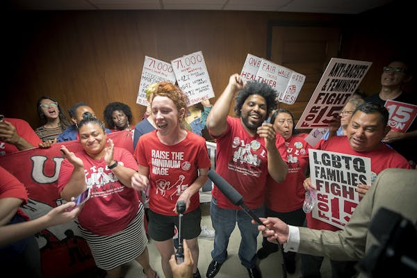 Minneapolis city council candidate Ginger Jentzen, center, celebrated with other supporters of the $15 minimum wage increase after it was passed by Ci