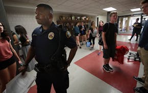 Cortez Hull, school resource officer (SRO) at Highland Park High School in St. Paul, monitored the hallways as classes let out for the day.