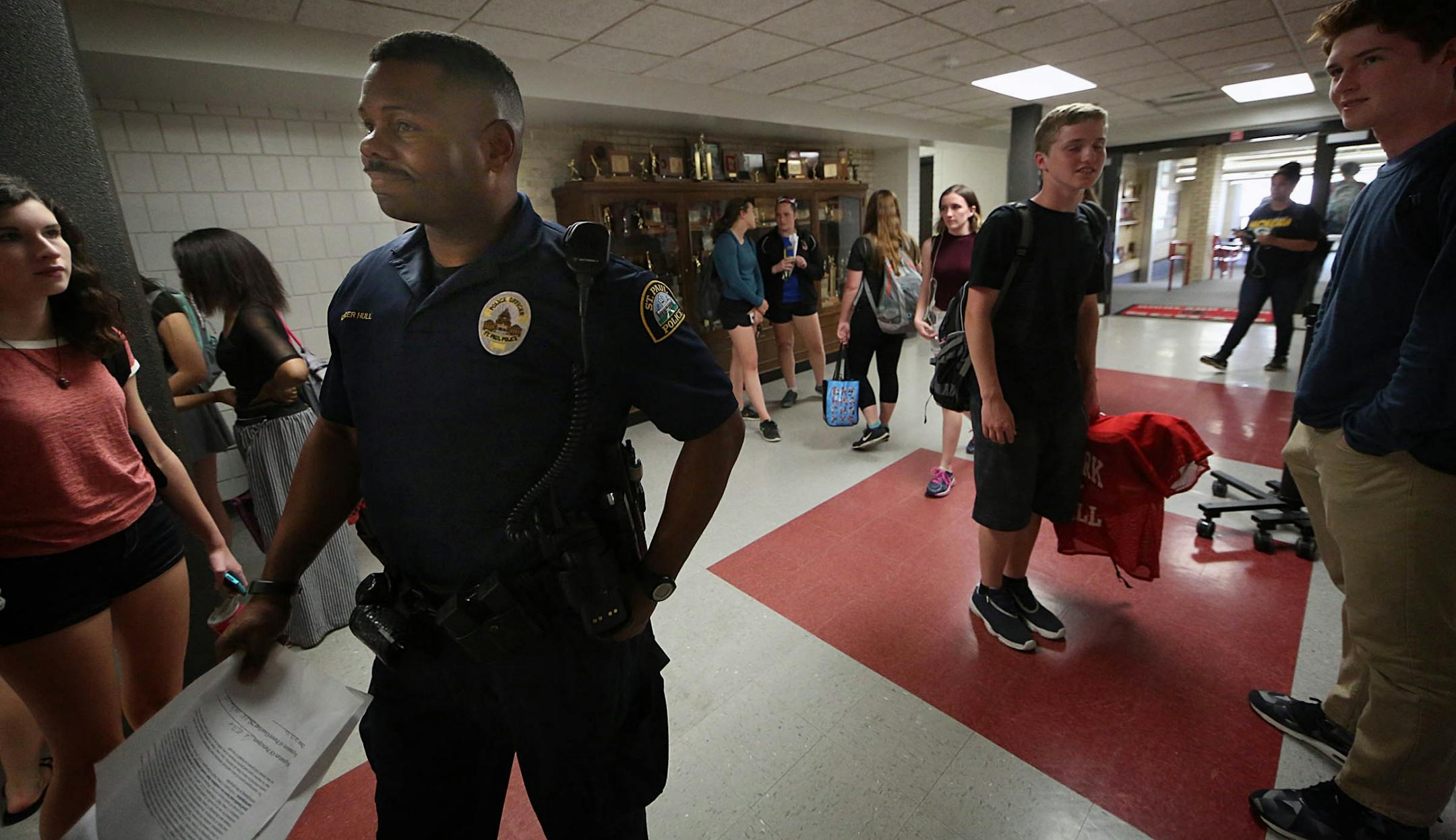 Cortez Hull, school resource officer (SRO) at Highland Park High School in St. Paul, monitored the hallways as classes let out for the day.