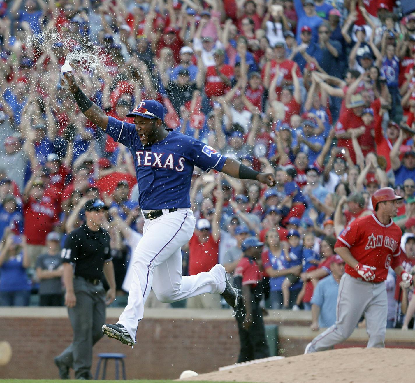 Texas Rangers' Hanser Alberto runs onto the field after the final out of the baseball game against the Los Angeles Angels in Arlington, Texas, Sunday, Oct. 4, 2015. The Rangers clinched the AL West title on the last day of the regular season with the 9-2 win. (AP Photo/LM Otero)