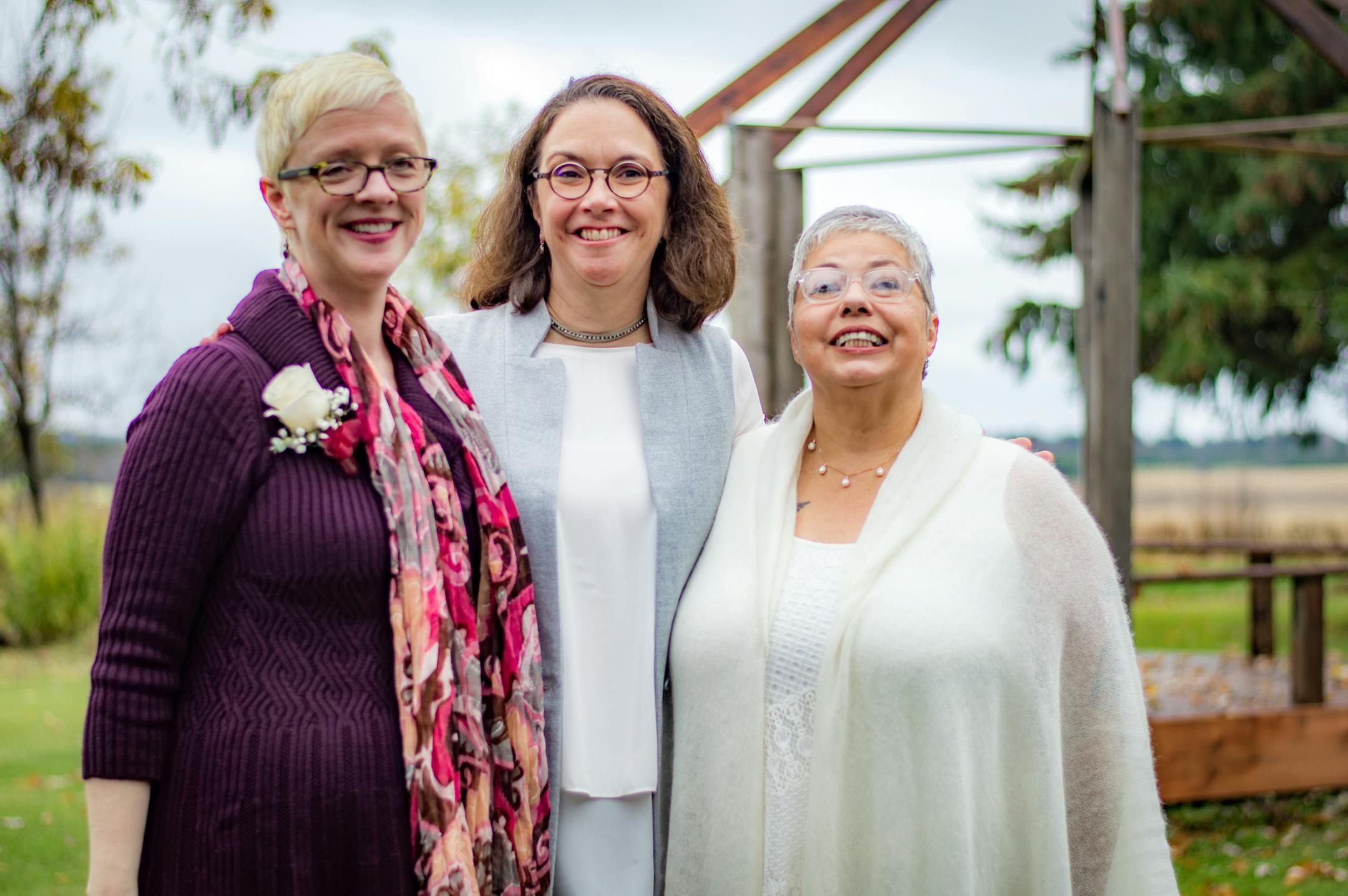 Kerry Peterson, left, officiated at the wedding of Barb Schulz, center, and Deb Balzer at a friend's farm in Wisconsin.