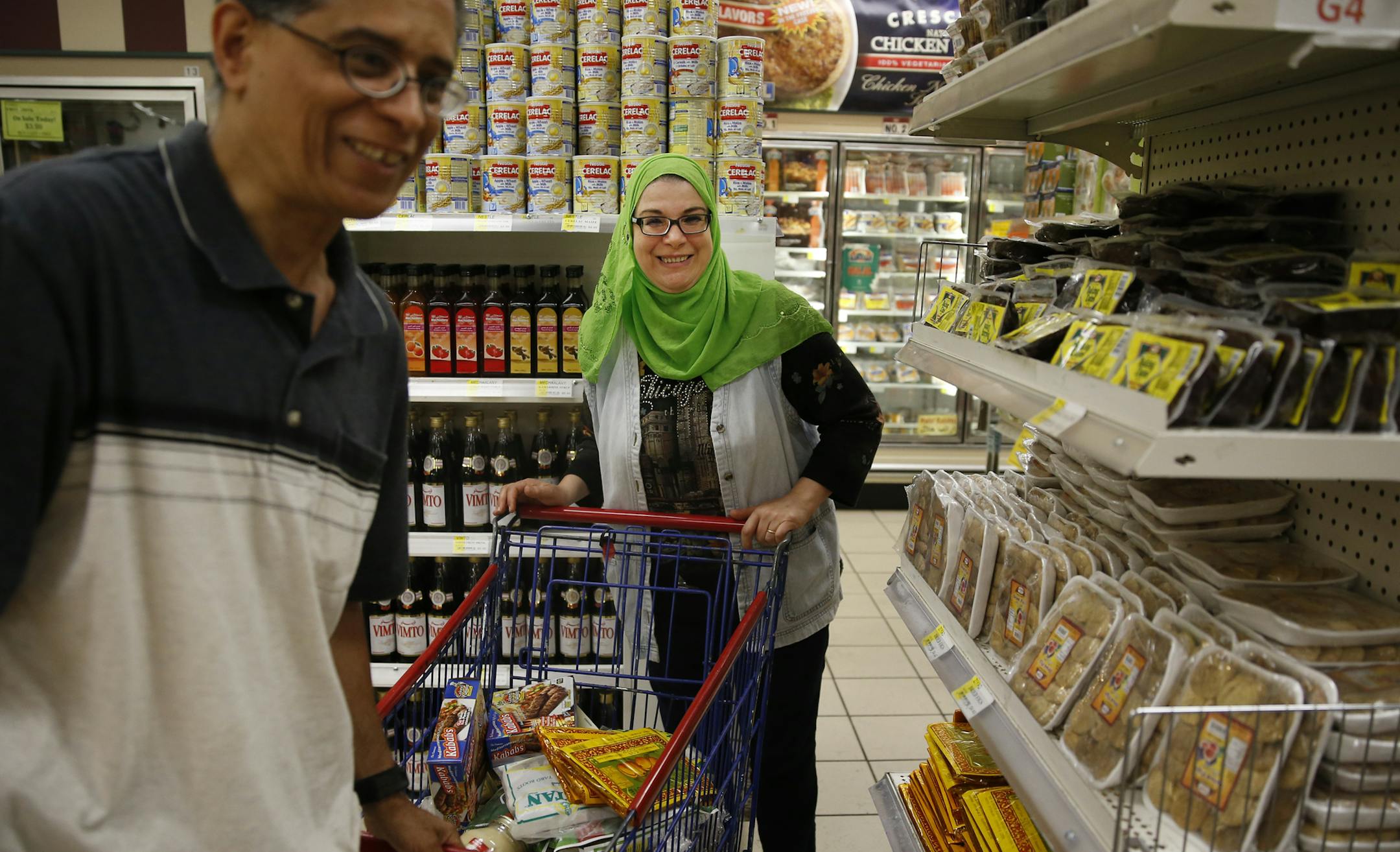 At Holy Land in north Minneapolis, Magdy Elyamany and wife Hwayda Badr(all cq) shopped for dates, pita bread, tahini, and desert in preparation for iftars, the evening meals when Muslims break fast during Ramadan which starts on Monday. ] tsong-taataarii@startribune.com