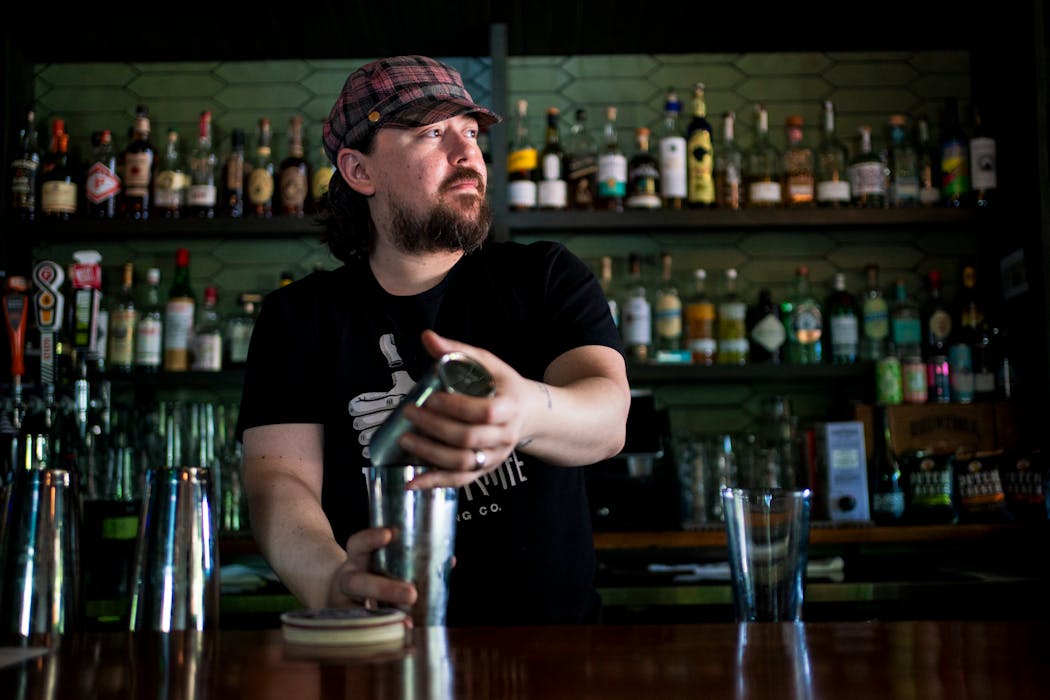 Keith Bohnen makes a cocktail at the White Squirrel Bar on West 7th Street on Thursday.