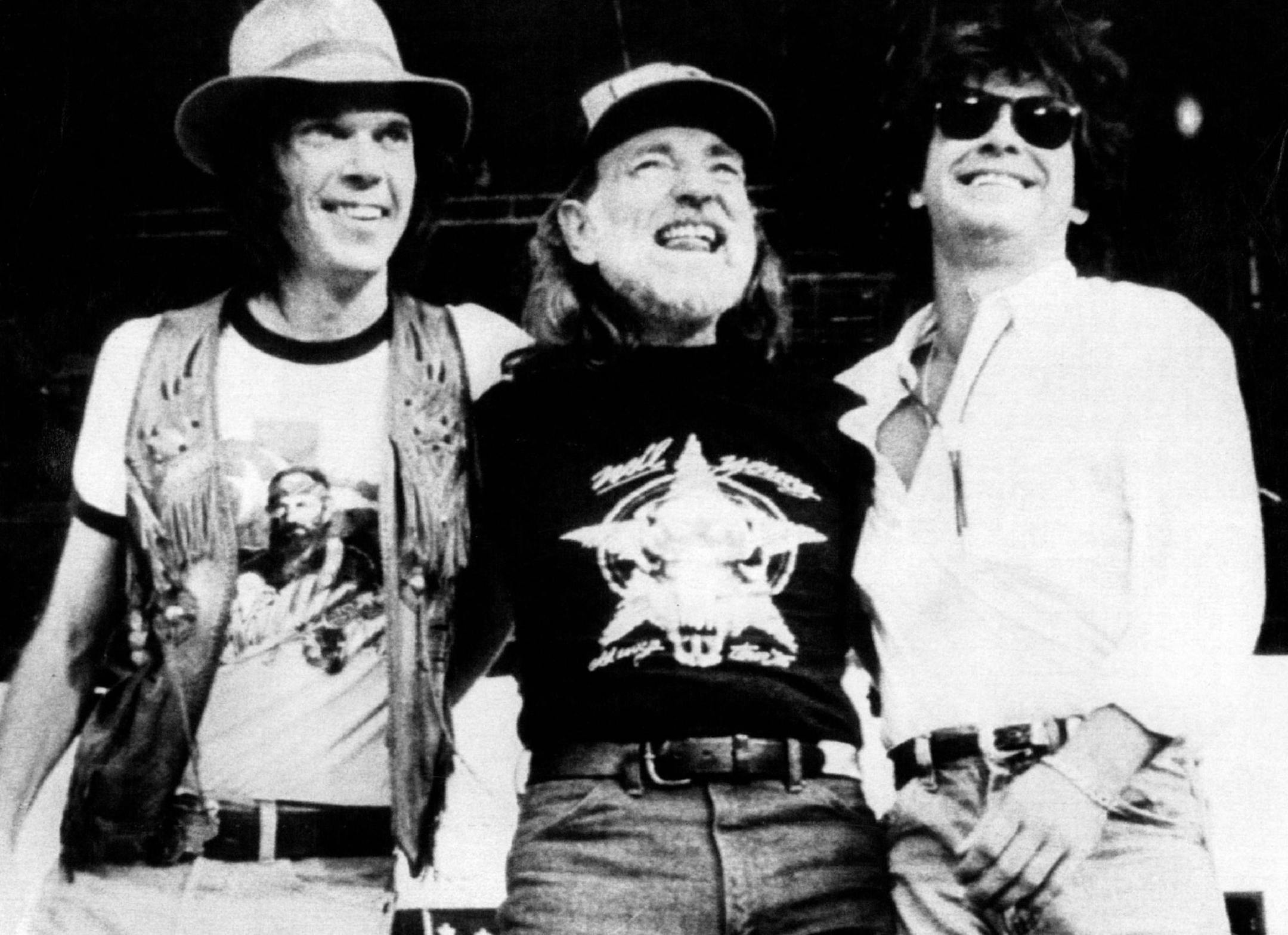 September 22, 1987 Farm-Aid organizers (L-R) Neil Young, Willie Nelson and John cougar Mellenkamp address 78,000 rain soaked spectators here 9/22/85 during 14-hour concert of country-western stars. The event raised $9 million for debt-ridden U.S. farmers. UPI