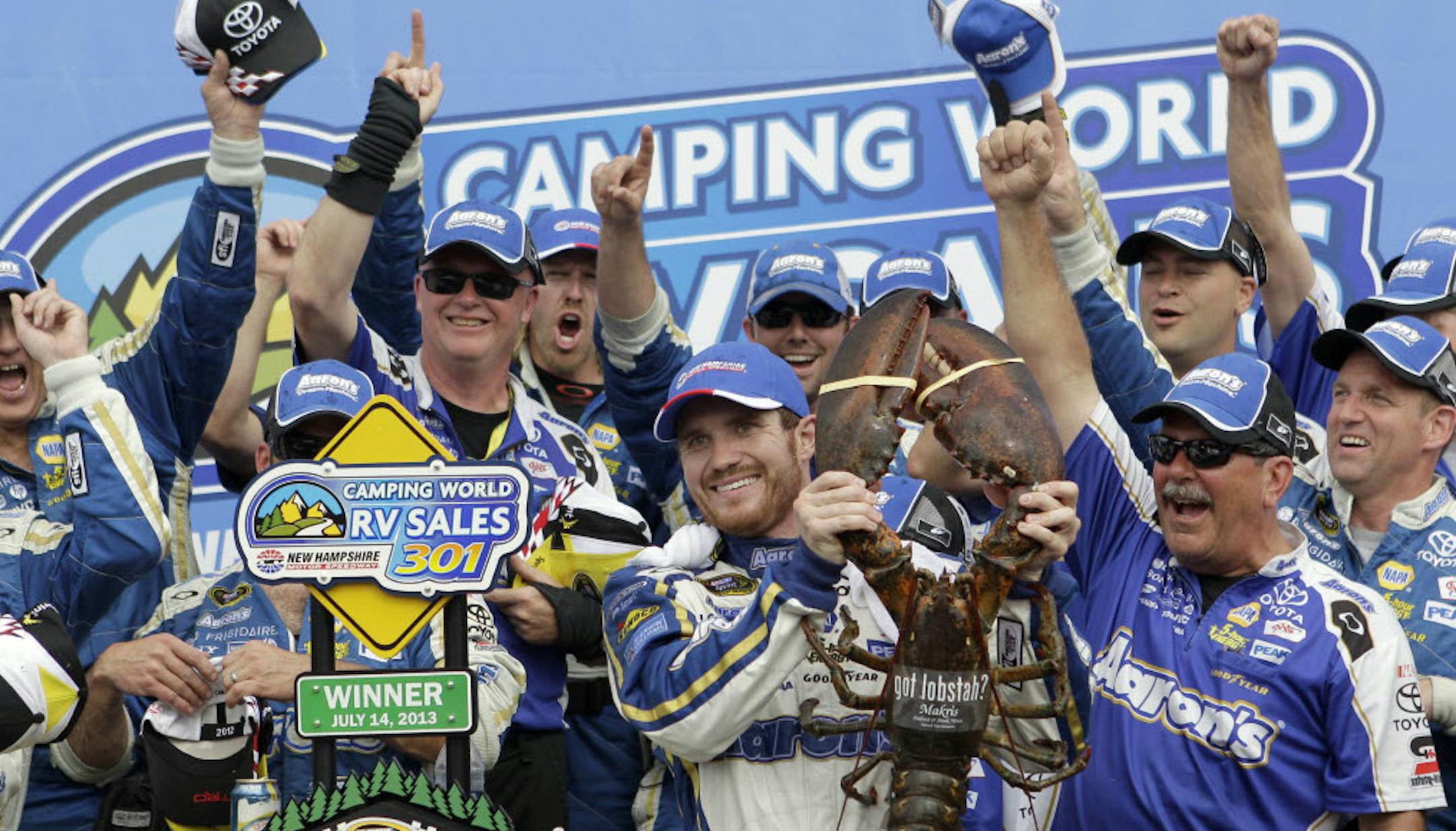 Brian Vickers celebrates with a giant lobster and his crew in victory lane after winning the NASCAR Sprint Cup Series race, Sunday, at New Hampshire Motor Speedway.