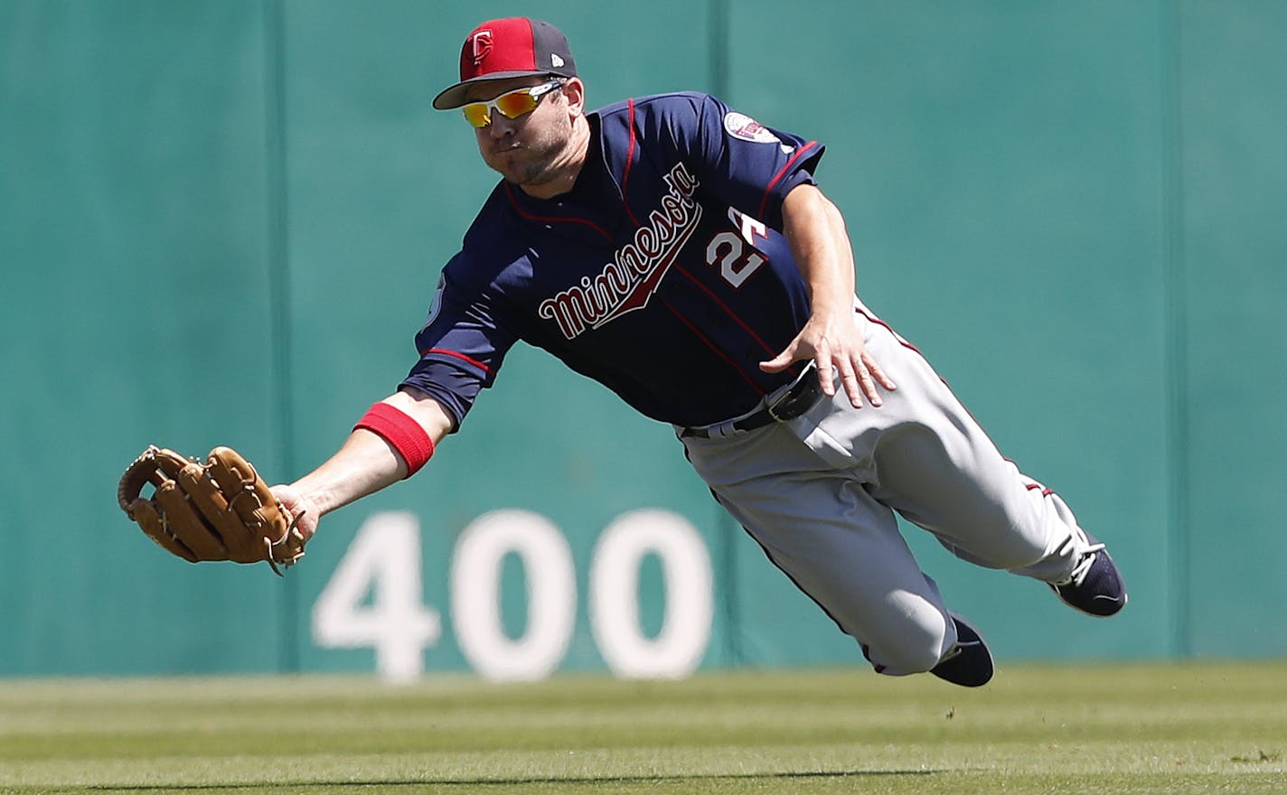 Minnesota Twins center fielder J.B. Shuck (24) makes a catch on a fly ball by St. Louis Cardinals' Kolten Wong in the first inning of a spring training baseball game Thursday, March 16, 2017, in Jupiter, Fla. (AP Photo/John Bazemore)