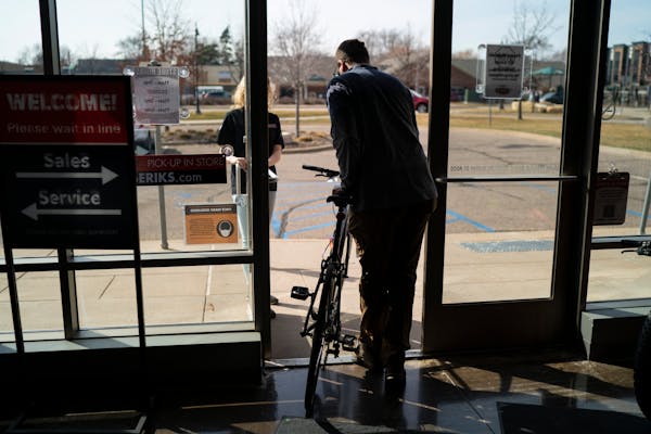 Kyle Williams of Minneapolis walked out of Erik's Bike Shop in Richfield, Minn., with a new bicycle on Friday, March 26, 2021.