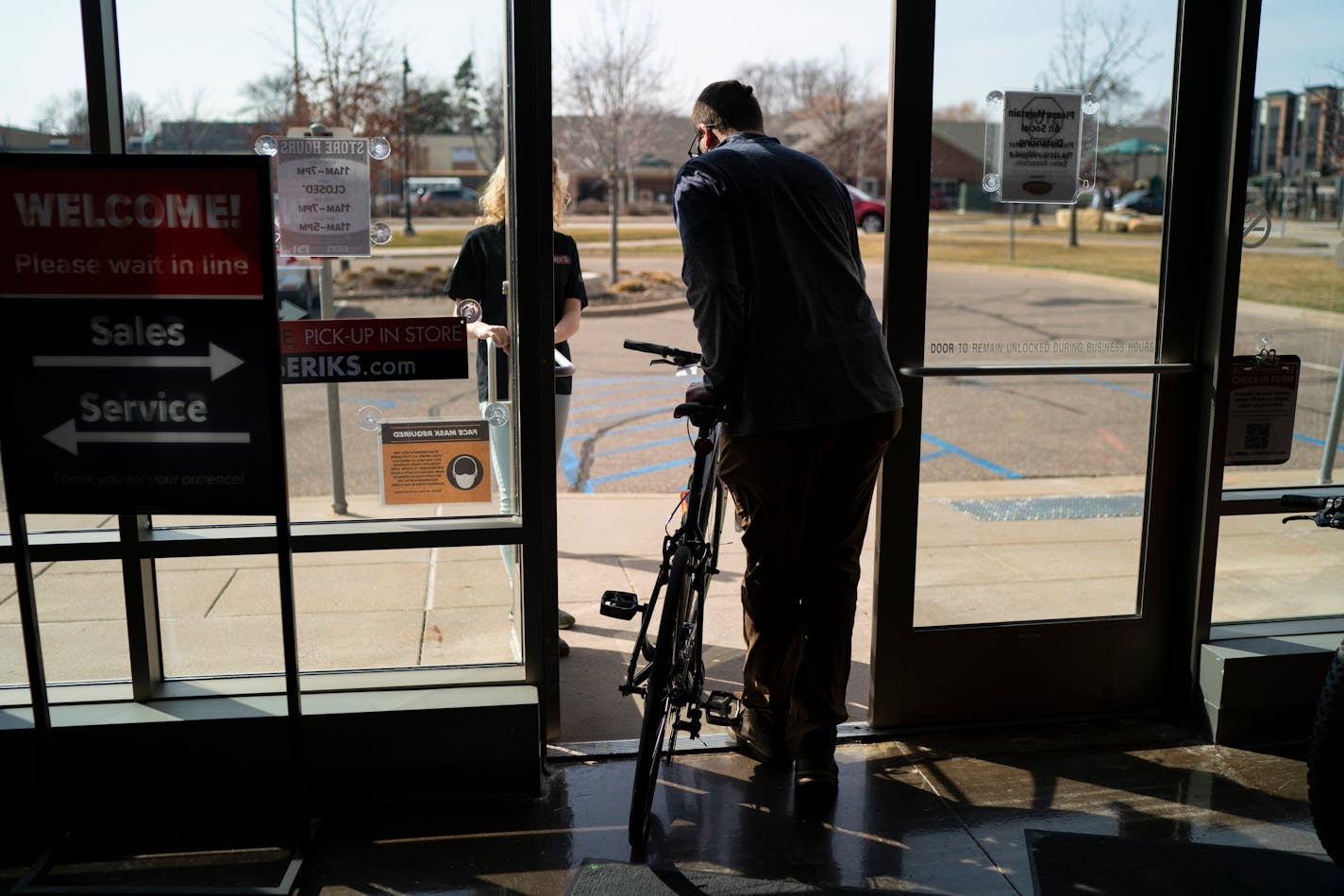 Kyle Williams of Minneapolis walked out of Erik's Bike Shop in Richfield, Minn., with a new bicycle on Friday, March 26, 2021.