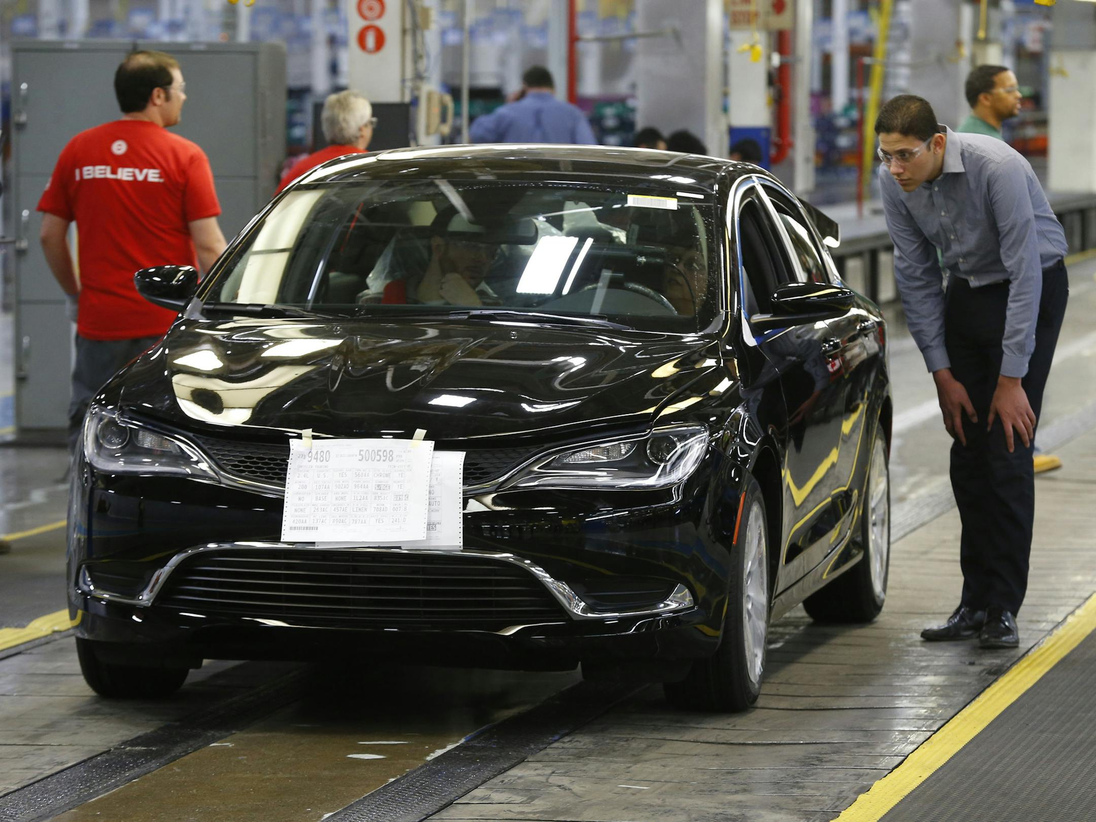 FILE - In this March 14, 2014 file photo, a 2015 Chrysler 200 automobile rolls down the assembly line at the Sterling Heights Assembly Plant in Sterling Heights, Mich. Fiat Chrysler says on Wednesday, April 6, 2016, it will lay off about 1,300 workers at an assembly plant north of Detroit this summer for an indefinite time due to slow sales of midsize cars made at the factory. (AP Photo/Paul Sancya, File)