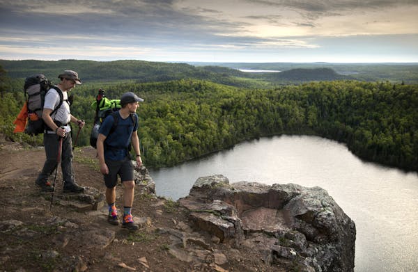 Day-7 - One of the most stunning vistas along the Superior Hiking Trail is the overlook at Bean Lake north of Silver Bay. Here, father and son hikers,