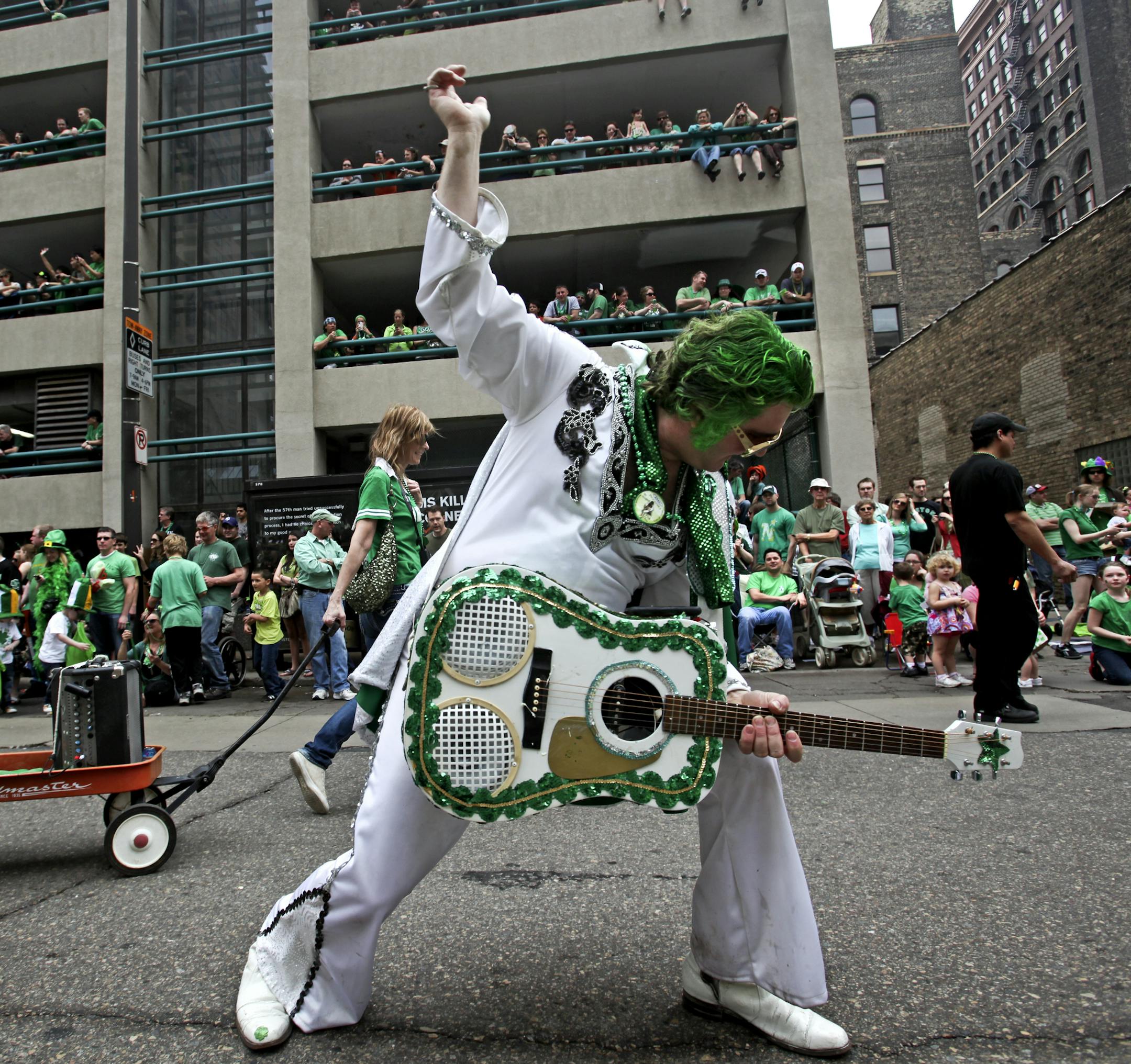 "Irish Elvis" Robert Klick of Golden Valley swiveled his hips to a huge crowd Saturday, March 17, 2012, during the annual St. Patrick's Day Parade in St. Paul, MN.] DAVID JOLES*djoles@startribune.com - The 46th Annual St. Patrick's Day Parade in St. Paul experienced both near-record temps and crowds while heading through downtown St. Paul on 5th Street.**Robert Klick,cq ORG XMIT: MIN2013031215154690