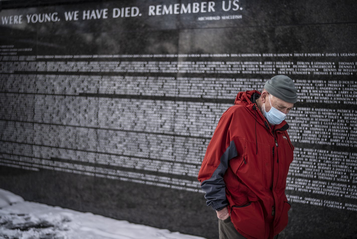 Tom Arneson of Brooklyn Center, a Vietnam Army artillery veteran, paid his respect Wednesday at the Veterans Day ceremony at the Minnesota Vietnam Memorial. The event was sponsored by the 173rd Airborne Brigade Association.