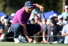 Jason Day lines up his putt on the 18th green during the third round of the Houston Open