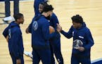 Timberwolves forward Anthony Edwards, right, high-fived center Karl-Anthony Towns after a presentation naming Edwards the Rookie of the Month for Marc