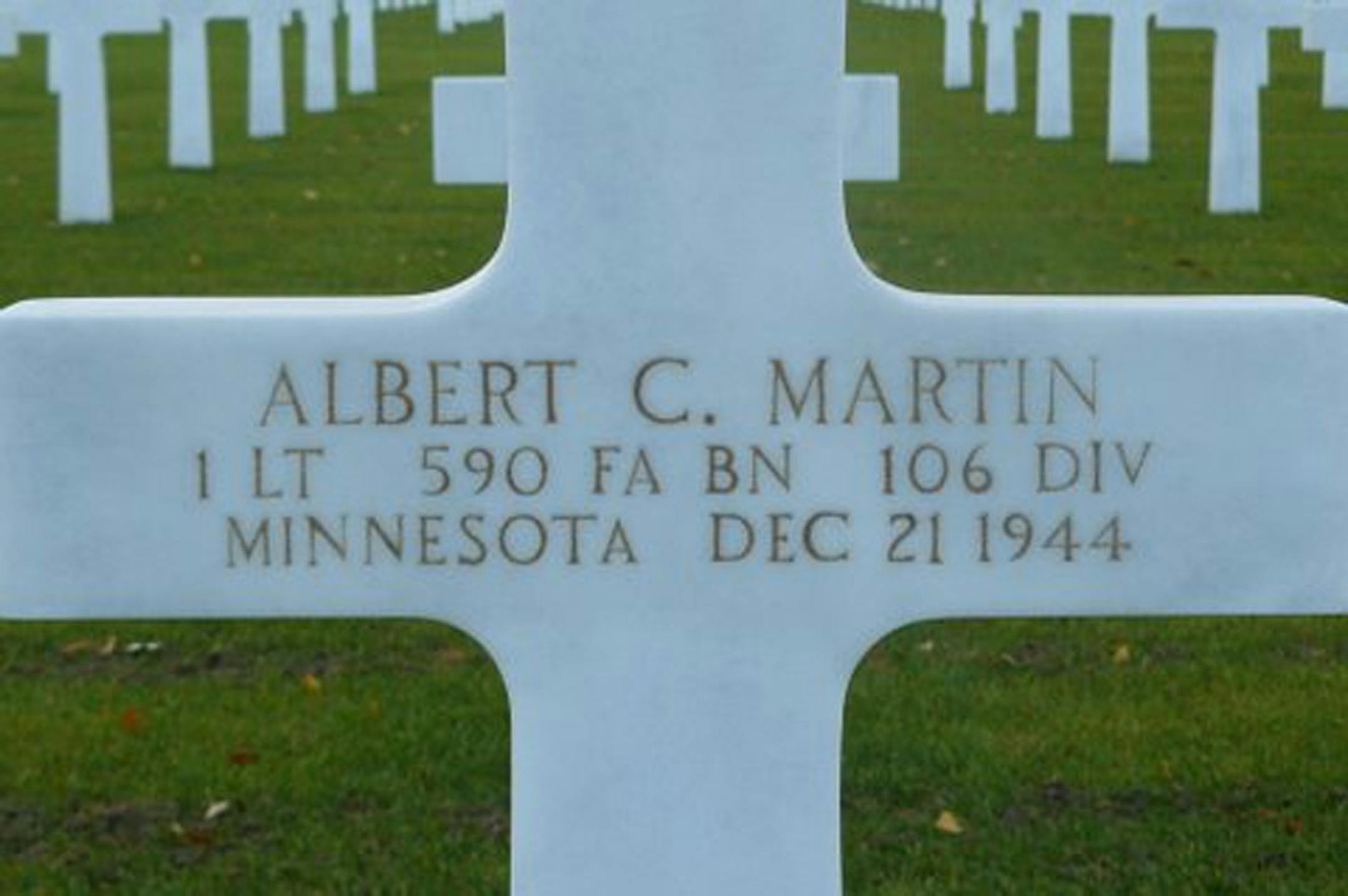 White marble cross marking Albert Martin's grave.
