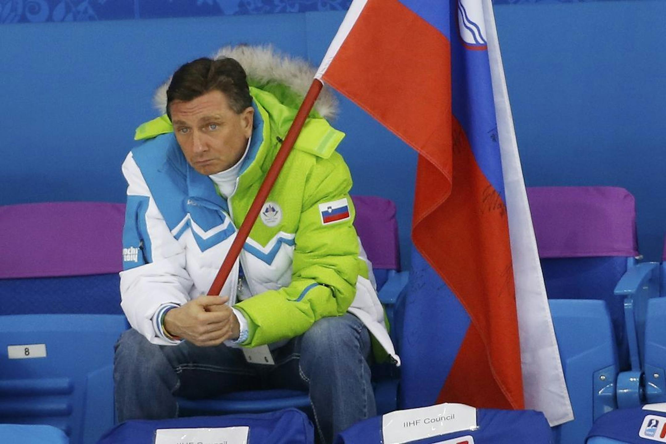 Slovenian President Borut Pahor watches Team Slovenia play Team USA to a 5-1 loss during the 2014 Winter Olympics men's ice hockey game at Shayba Arena Sunday, Feb. 16, 2014, in Sochi, Russia.