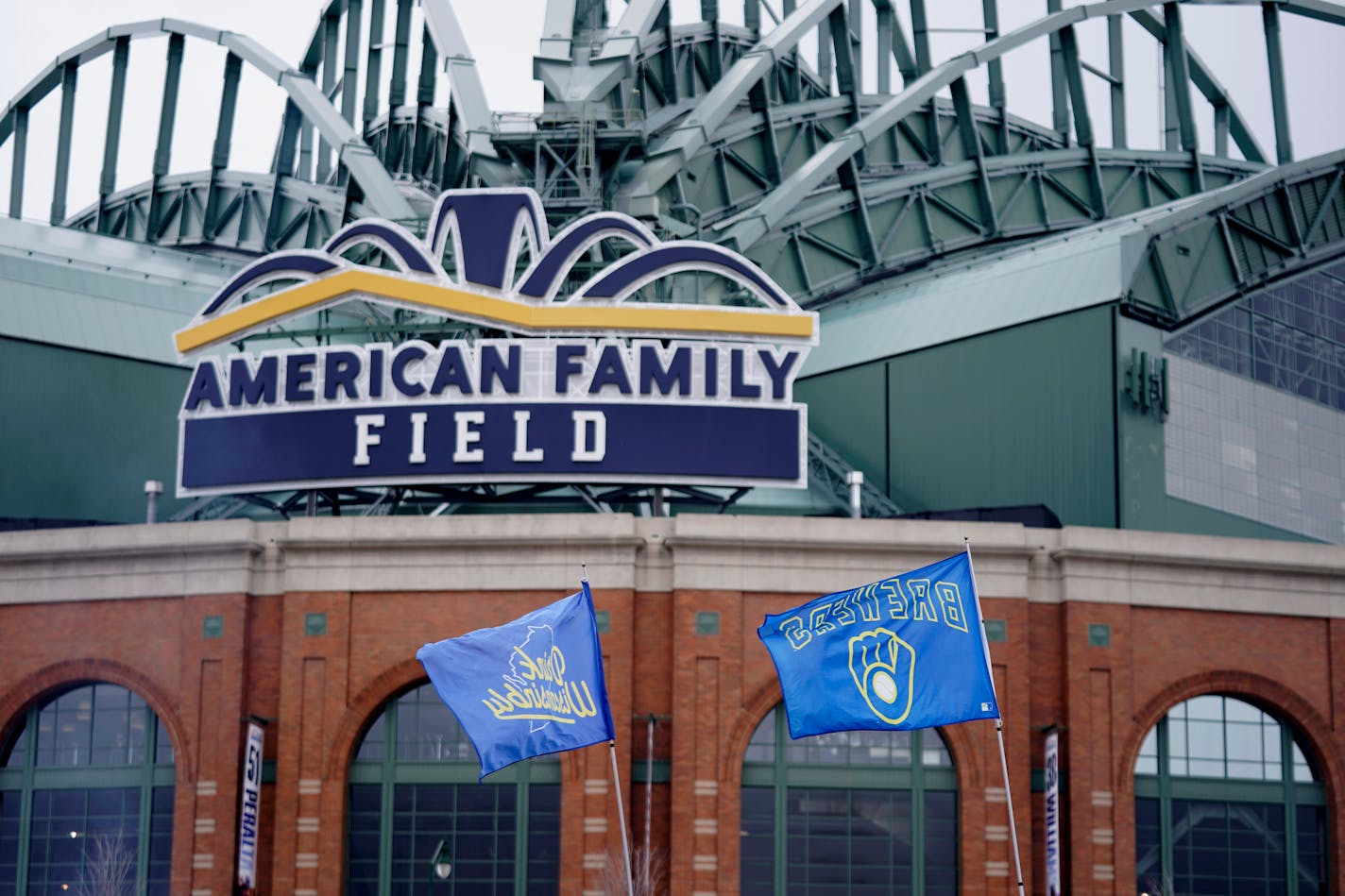 Flags fly in front of American Family Field before a baseball game between the Milwaukee Brewers and the New York Mets Monday, April 3, 2023, in Milwaukee. (AP Photo/Aaron Gash)