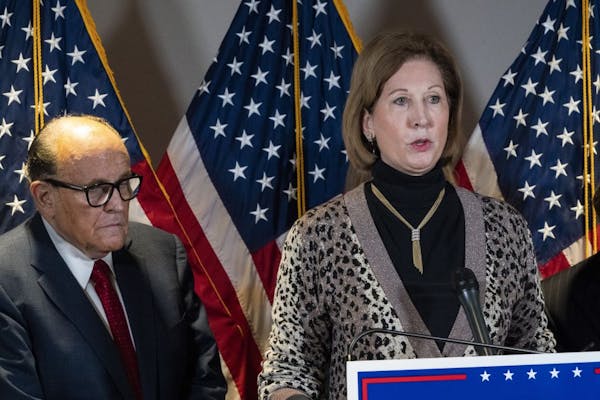 Sidney Powell, right, speaks next to former New York Mayor Rudy Giuliani, as members of President Donald Trump's legal team, during a news conference 