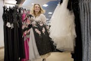 Ali-Jae Nicolai, 17, a junior at New Prague High School, carries a selection of dresses while shopping for prom dresses at Macy's at the Mall of Ameri