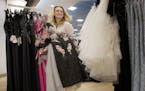 Ali-Jae Nicolai, 17, a junior at New Prague High School, carries a selection of dresses while shopping for prom dresses at Macy's at the Mall of Ameri