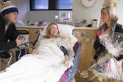 KARE 11 reporter Lindsey Seavert, with basket in hand, met with Jon and Jenny Tichich of Apple Valley in the antepartum unit at University of Minnesot