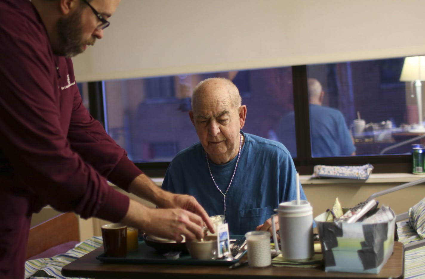 John Kaiser, an overnight nurse at Our Lady of Peace, helped Harold Yannerelly uncover his breakfast early Wednesday morning at Our Lady of Peace in St. Paul. ] JEFF WHEELER &#x201a;&#xc4;&#xa2; jeff.wheeler@startribune.com Harold Yannerelly moved into Our Lady of Peace's end of life residential care facility in St. Paul in May and has been grateful for the care he's received. He was photographed in his room Wednesday morning, September 17, 2014. ORG XMIT: MIN1409171630382452