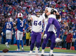 A Vikings offensive lineman lifted up Minnesota Vikings wide receiver Justin Jefferson (18) after he got the ball down to the 1-yard line late in the 