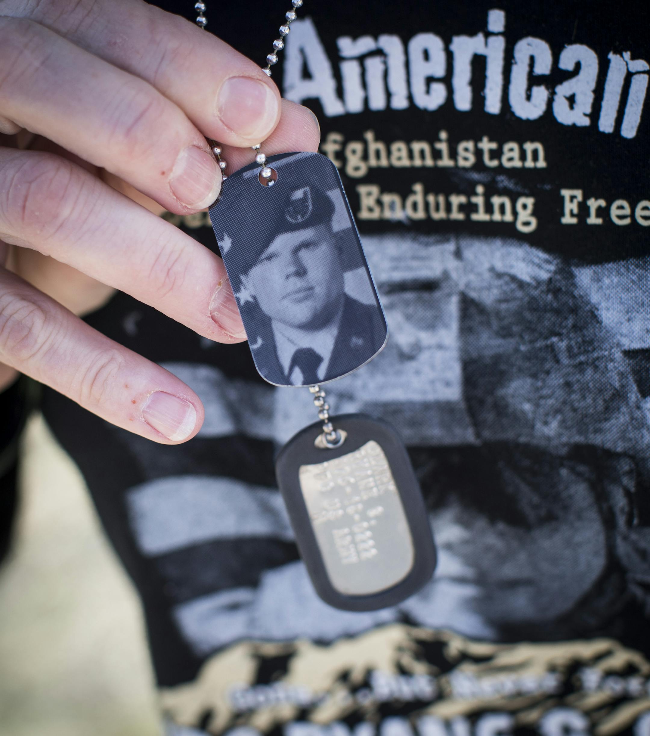 Tracy Clark held up dog tags of her son Ryane Clark who was killed while serving in Afghanistan. She was photographed at her home in New London, Minn., on Friday, April 10, 2015. ] RENEE JONES SCHNEIDER • reneejones@startribune.com Ryane CQ