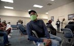Erick Smith waits to receive his first round of the Moderna COVID-19 vaccine at a vaccination site at Greater Emmanuel Institutional church in Detroit