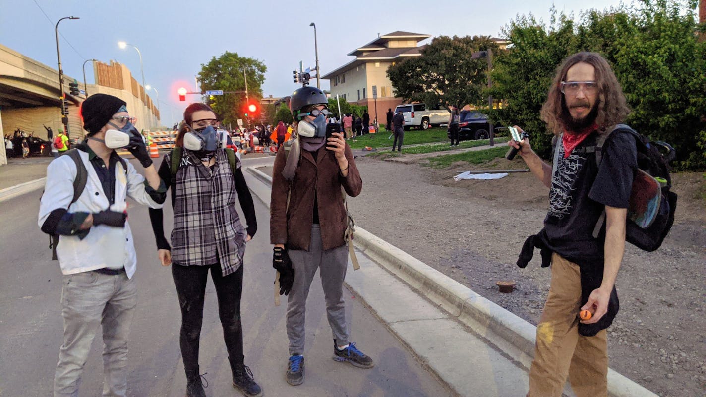 The group of volunteer medics enjoyed a moment of peace before the violent protests began on Saturday night. They are, from left, Jordan Vonmandel, Claire Indritz, Josh Phillips and Mason Packard, all in their 20s.